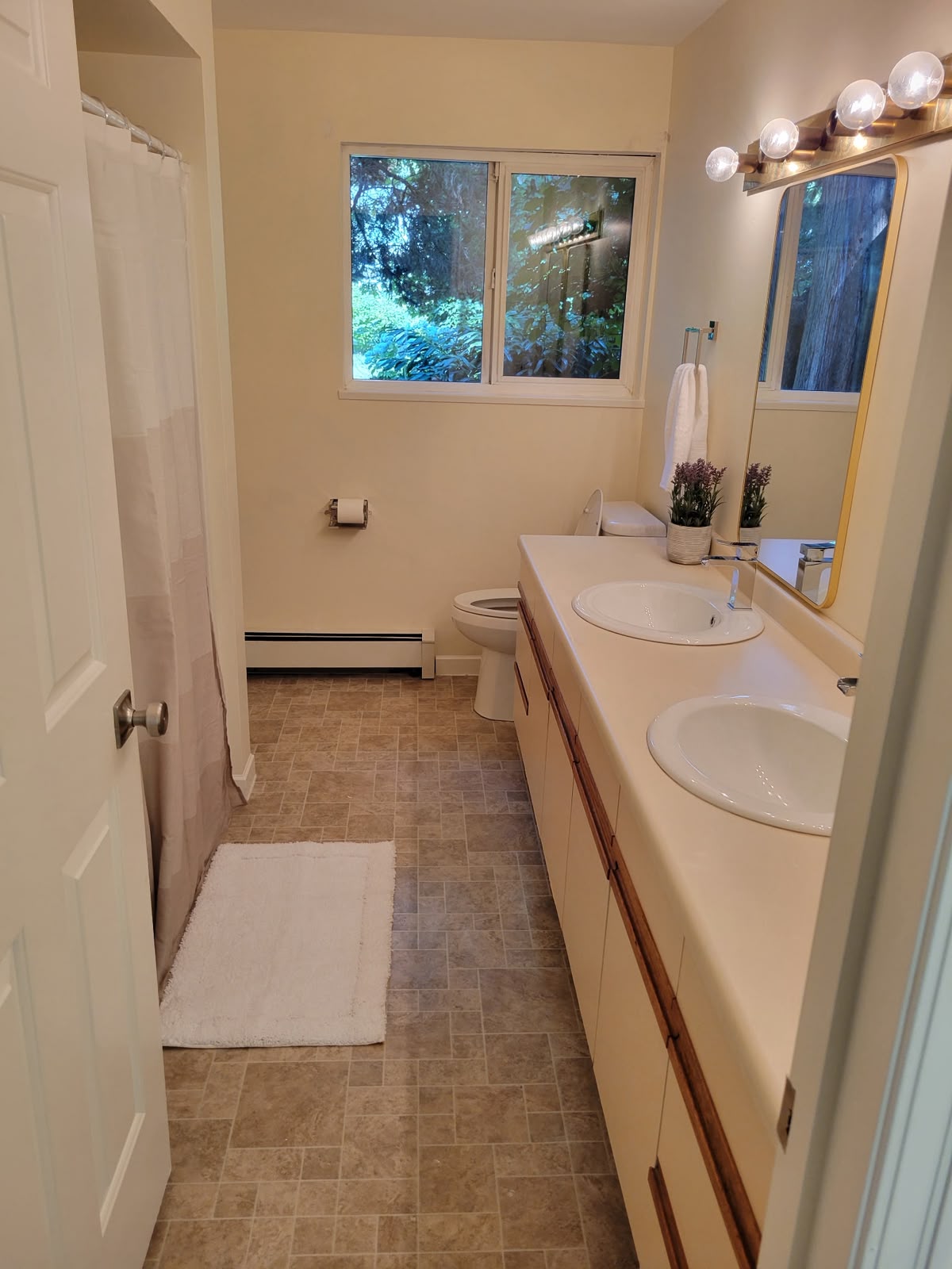 Bathroom with double vanity and shower