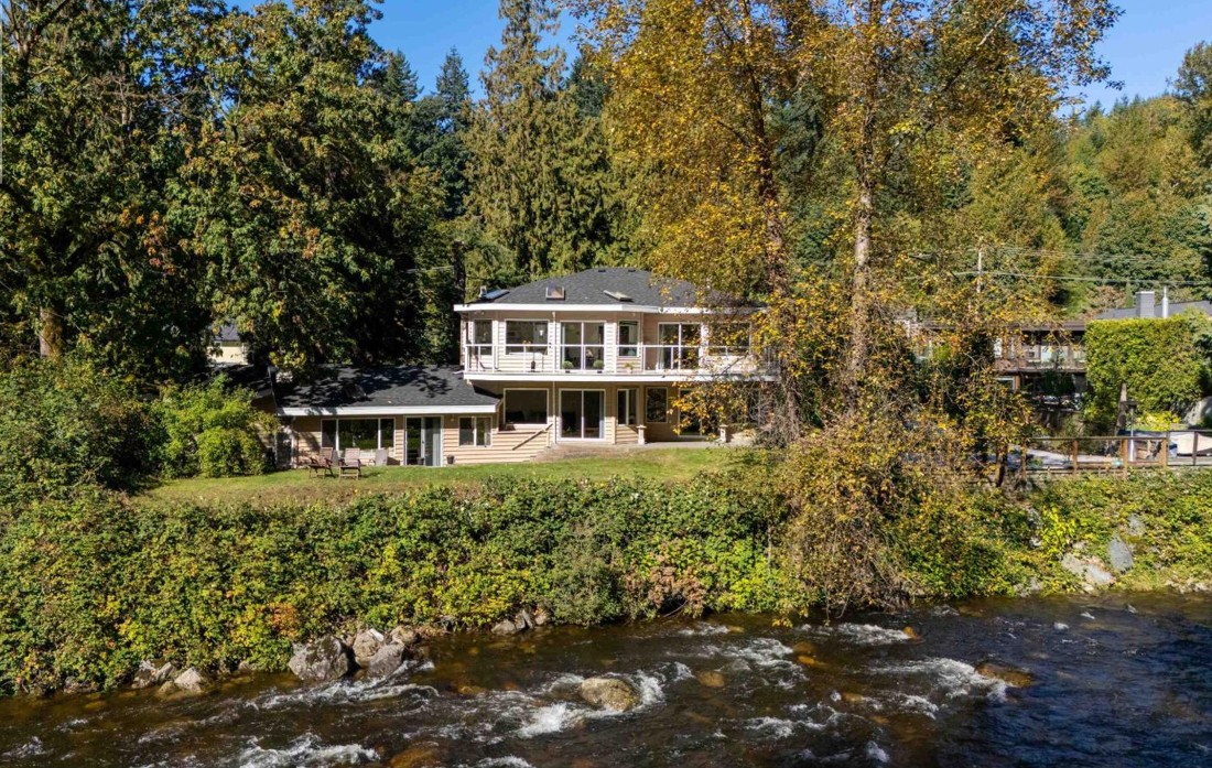 The rear of the house and garden-level suite seen from across the river