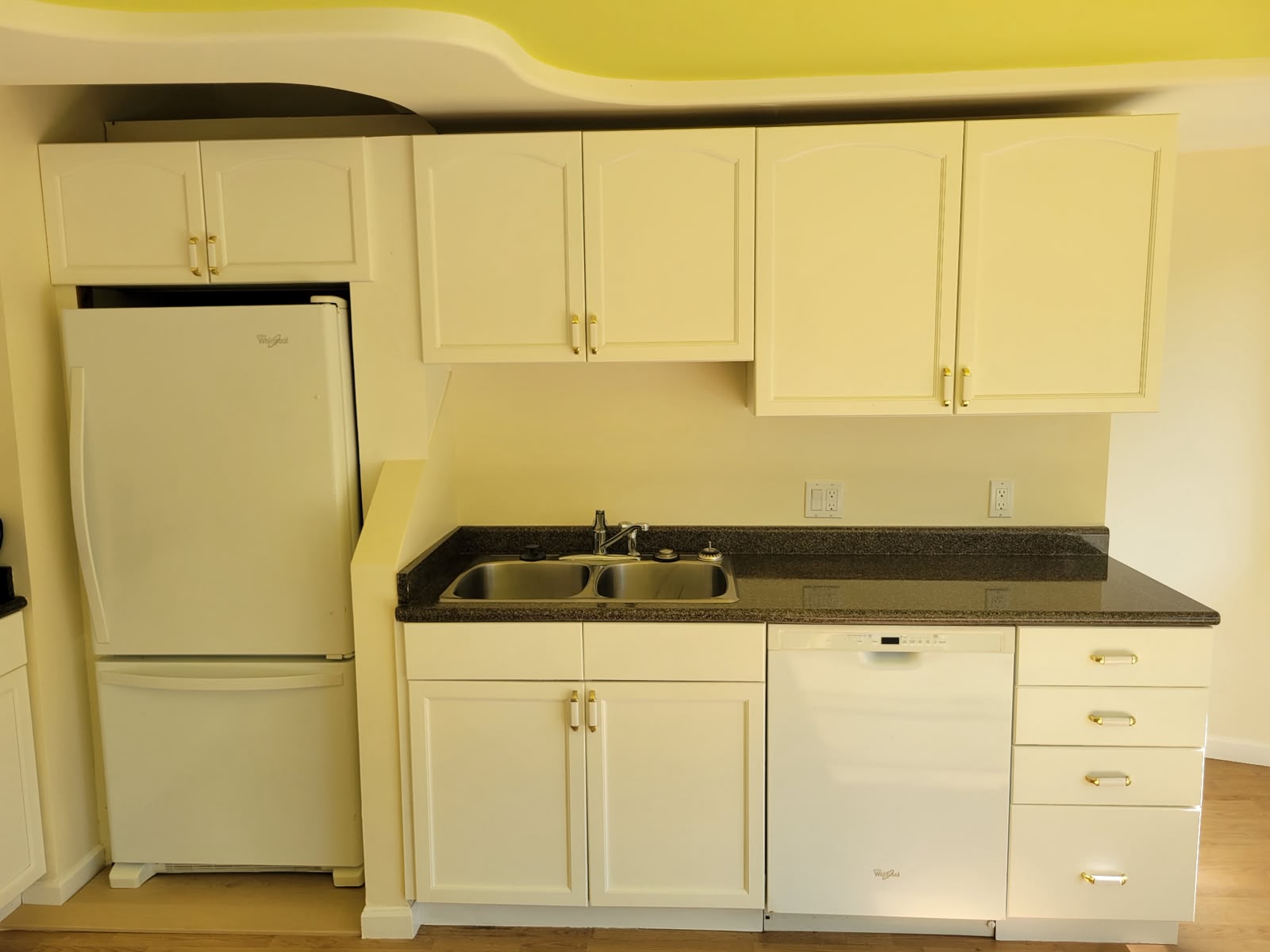 Kitchen with granite counters, fridge and dishwasher