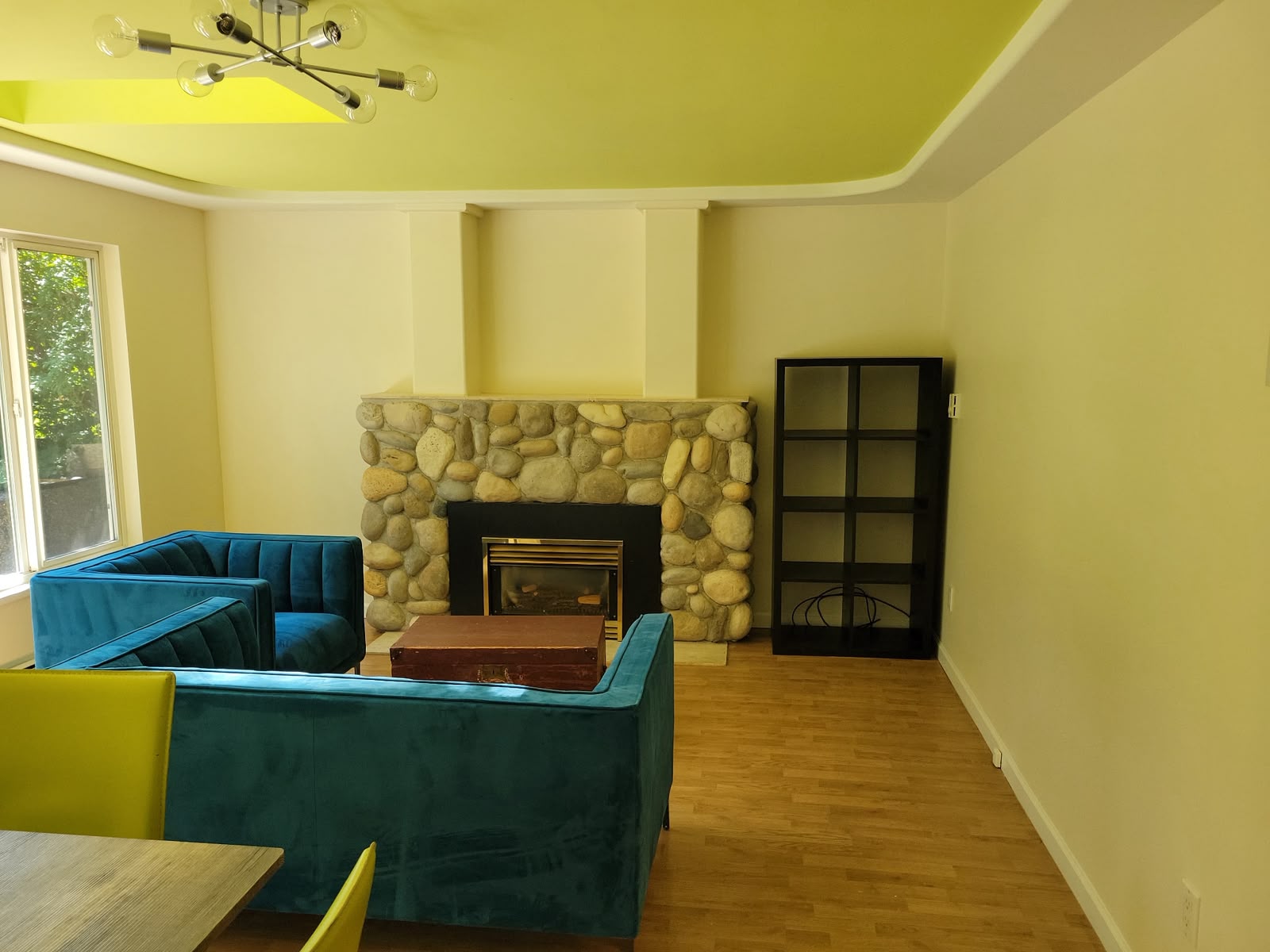 Living room with river-stone fireplace and velvet seating