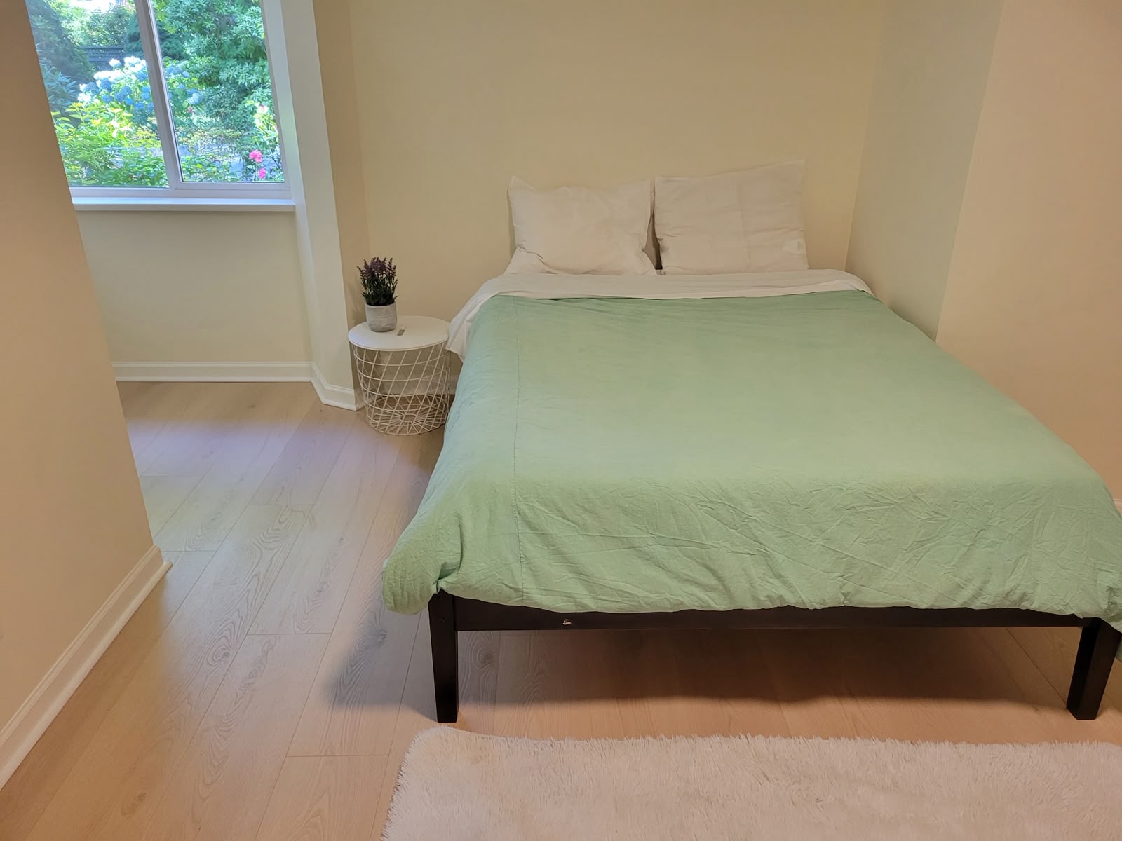 Primary bedroom with queen bed and garden window